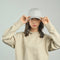 Woman wearing a light grey cap and beige sweatshirt, adjusting the brim – ideal for custom branded caps, streetwear promotions, and casual club uniforms with no minimum order in Australia.