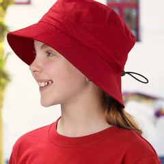 Smiling child wearing a bright red bucket hat with drawcord and matching T-shirt – ideal for custom school hats, sun-safe uniforms, and eco-friendly headwear options in Australia.