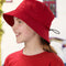Smiling child wearing a bright red bucket hat with drawcord and matching T-shirt – ideal for custom school hats, sun-safe uniforms, and eco-friendly headwear options in Australia.