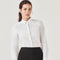 Woman wearing a crisp white long sleeve business shirt tucked into a black skirt – ideal for custom branded corporate uniforms, hospitality staff wear, and professional office attire in Australia.