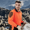 Construction worker wearing long sleeve hi-vis orange and black polo shirt on job site – custom safety workwear with free logo included.
