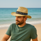 Man relaxing on the beach wearing a straw hat with a “Summer Time” band – ideal for custom branded straw hats for outdoor events, beach promotions, and sun-safe merchandise in Australia.