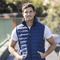**Alt Text:** Man wearing royal blue custom puffer vest outdoors – personalised corporate vest with free logo included, ideal for staff uniforms and business branding.