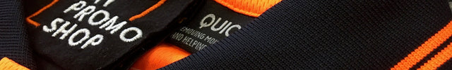 Close-up of high-quality custom branded orange polo shirt with black collar and vibrant orange stripes, featuring a woven label of My Promo Shop, Australia's trusted supplier for personalised workwear and uniforms.